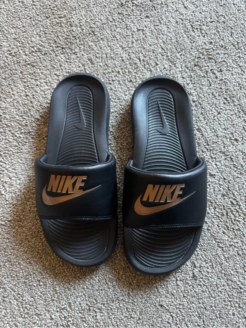 Nike Black Slides with Metallic Bronze Logo